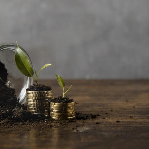 jar-with-dirt-stacked-coins-with-copy-space.jpeg